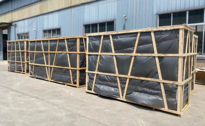 Island freezers carefully packed in sturdy wooden crates outdoors, ready for export and shipping.