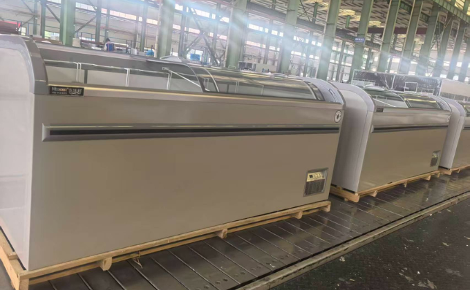 Neatly arranged white island freezers on a production line, showcasing manufacturing craftsmanship.