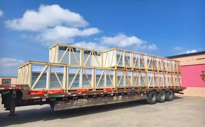 Commercial refrigerators packed in reinforced wooden crates loaded on a truck for safe global shipping.