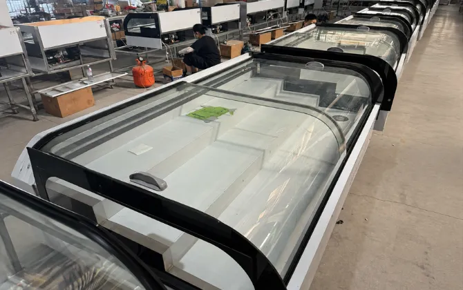 Mass production line of horizontal curved glass countertop display refrigerators in a professional manufacturing facility for OEM projects.