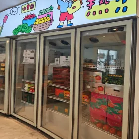 Multiple glass door refrigerators installed in a fruit shop