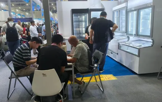 Visitors speaking with our team beside the refrigeration display